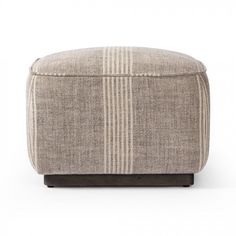 a small ottoman that is made out of fabric and has stripes on the top, along with