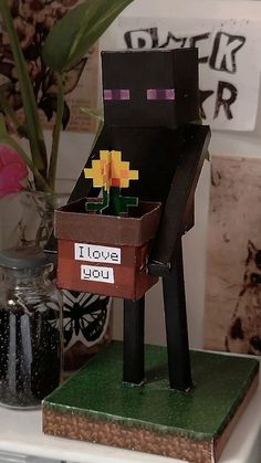 a paper mache sitting on top of a wooden chair next to a potted plant