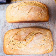 two loaves of bread sitting on top of a counter