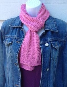 a pink knitted scarf on a mannequin