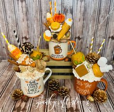 three coffee mugs filled with different types of food and candy on top of each other