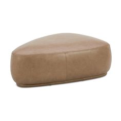 a tan leather ottoman sitting on top of a white floor