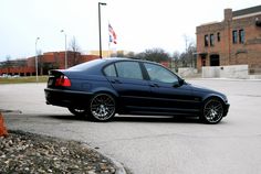 a black car is parked in the parking lot