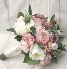 a bridal bouquet with pink and white flowers