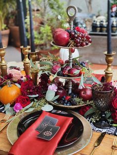 the table is set with fruit and candles