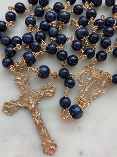 "This is a beautiful rosary!  *All metal parts are 14K gold.   Beads: 6 and 8mm Sapphire Wire: 20 gauge 14K gold wire Bead Caps and Chain: 14K Gold Rosary Centerpiece and Crucifix: 14k Gold I had these medals cast using the lost wax casting method in the United States. The rosary parts can be cast in gold, silver or bronze. Only the markings from the original \"Master\" medal will appear so these medals are not marked with their metal content." Beautiful Rosaries, Beautiful Rosary, Gold Rosary, The Rosary, Wax Casting, Lost Wax Casting, Lost Wax, Gold Wire, Bead Caps