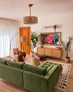 a living room filled with furniture and a flat screen tv on top of a wooden table