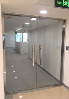 an empty office with glass doors and no people