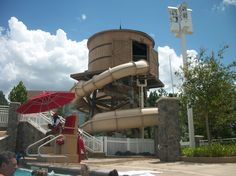 a large water slide next to a swimming pool