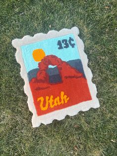 a patch with the number thirteen on it laying in the grass next to a frisbee