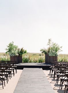 rows of chairs are set up for an outdoor ceremony