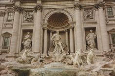 statues and fountains in front of a building