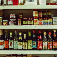 shelves filled with various types of condiments and sauces