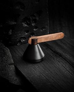 a wooden handle on top of a black object