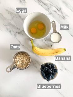 ingredients to make banana blueberry muffins laid out on a marble counter top