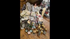 a table topped with lots of different types of brooches and other things on top of it