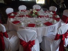 the table is set with white and red linens