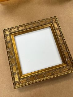 a gold frame sitting on top of a table