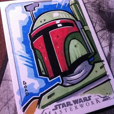 a card with a drawing of a boba fett helmet on it