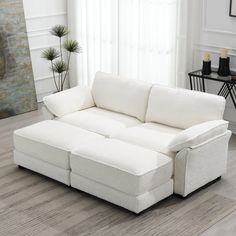 a white couch sitting on top of a hard wood floor