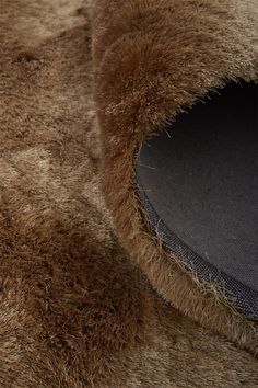 a close up view of a furry animal's fur with the hood pulled back