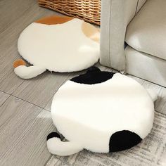 a cat rug on the floor next to a couch