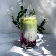 a vase with flowers in it sitting on a table