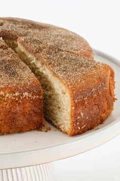 a cake that has been cut into pieces on a white plate with one slice missing