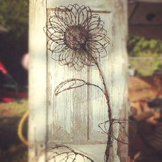 an old door with a flower drawn on it