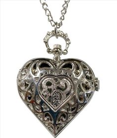 Victorian Trading Timeless Heart Watch Necklace 28D Victorian Trading Company Heart Watch Necklace A lustrous, alluring heart-shaped locket with intricate filigree encloses a watch that keeps time as it rests close to its wearer's heart. 2 1/4 x 2" locket. 15 1/2" chain. Metal alloy. Style: #55 NE 5532960   Contact Us: For eBay customer service inquiries, please message us through eBay messaging OR  at 18889151535   Powered by SixBit's eCommerce Solution Silver Quartz Watches For Valentine's Day, Elegant Silver Watch For Valentine's Day, Valentine's Day Elegant Silver Watch, Silver Heart-shaped Watch For Valentine's Day, Timeless Silver Heart Jewelry, Elegant Heart-shaped Watch As Gift, Silver Watch For Valentine's Day Gift, Elegant Heart-shaped Watch For Gift, Silver Watches For Valentine's Day Gift