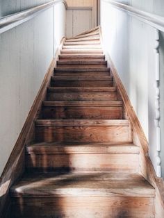 a set of wooden stairs leading up to an open door