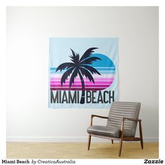 a chair sitting in front of a wall with a sign that says miami beach on it