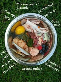 a bowl filled with meat and vegetables on top of grass