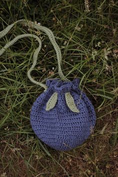 a crocheted bag sitting in the grass