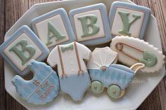 baby shower cookies are arranged on a plate