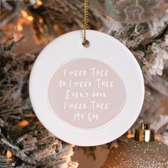 a ceramic ornament with the words i need three on it hanging from a christmas tree