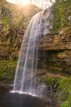 a large waterfall with water cascading down it's side