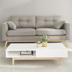 a white coffee table sitting in front of a couch