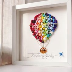 a colorful hot air balloon in a white frame