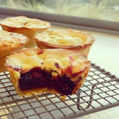 several small pies sitting on a cooling rack