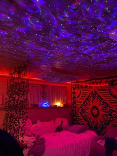 a bedroom with purple and blue lights on the ceiling