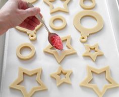 a person is spooning out some food into the shape of stars and circles on a tray