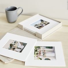 three pictures are placed next to a coffee cup on a table with a mug in the background