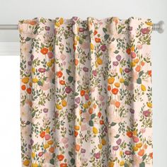 the curtain is hanging in front of a window with flowers and leaves printed on it