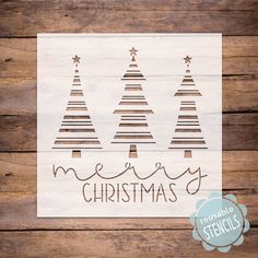 a wooden sign that says merry christmas with three trees