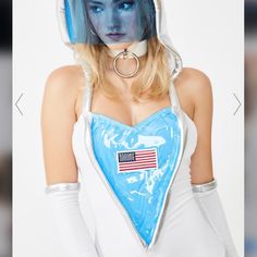 a woman with blue makeup and white bodysuit wearing an american flag bandanna hat