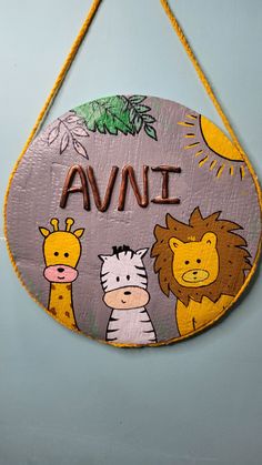 a wooden sign with animals and the word avai on it hanging from a rope