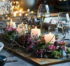 a table with candles and flowers on it