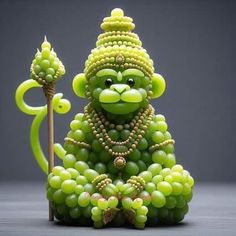 a monkey made out of grapes sitting on top of a table