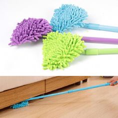 three different types of mop heads laying on top of a wooden floor next to a bed